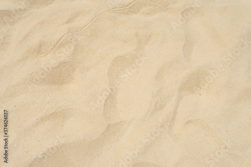 Beach sand texture in summer day as background