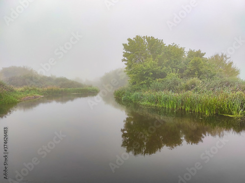 River in the fog. Autumn landscape in cloudy weather