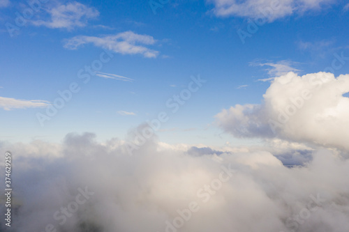 Aerial view white clouds in blue sky. View from drone. Aerial top view cloudscape texture. Texture of clouds. View from above. Panorama clouds background