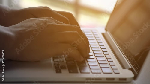 Businessman working on tablet computer,Extreme close-up human hands on keyboard 4K. businessman hands type on laptop keyboard business 4K Hands touch typing pointing cloud data social network media. photo