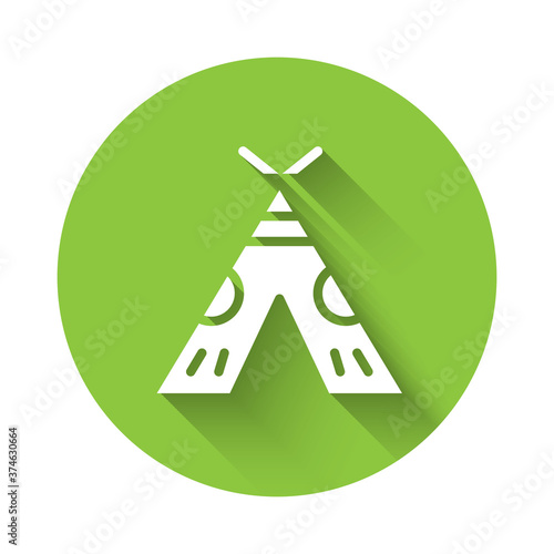 White Traditional indian teepee or wigwam icon isolated with long shadow. Indian tent. Green circle button. Vector Illustration.