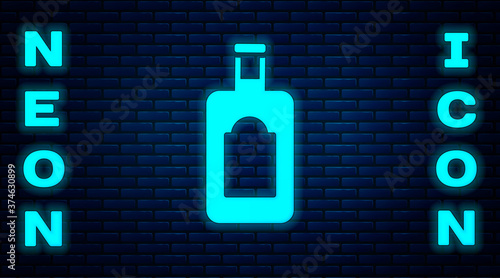 Glowing neon Whiskey bottle icon isolated on brick wall background. Vector Illustration.