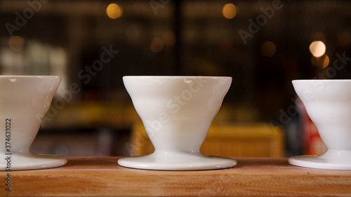 white ceramic cups against blurry background