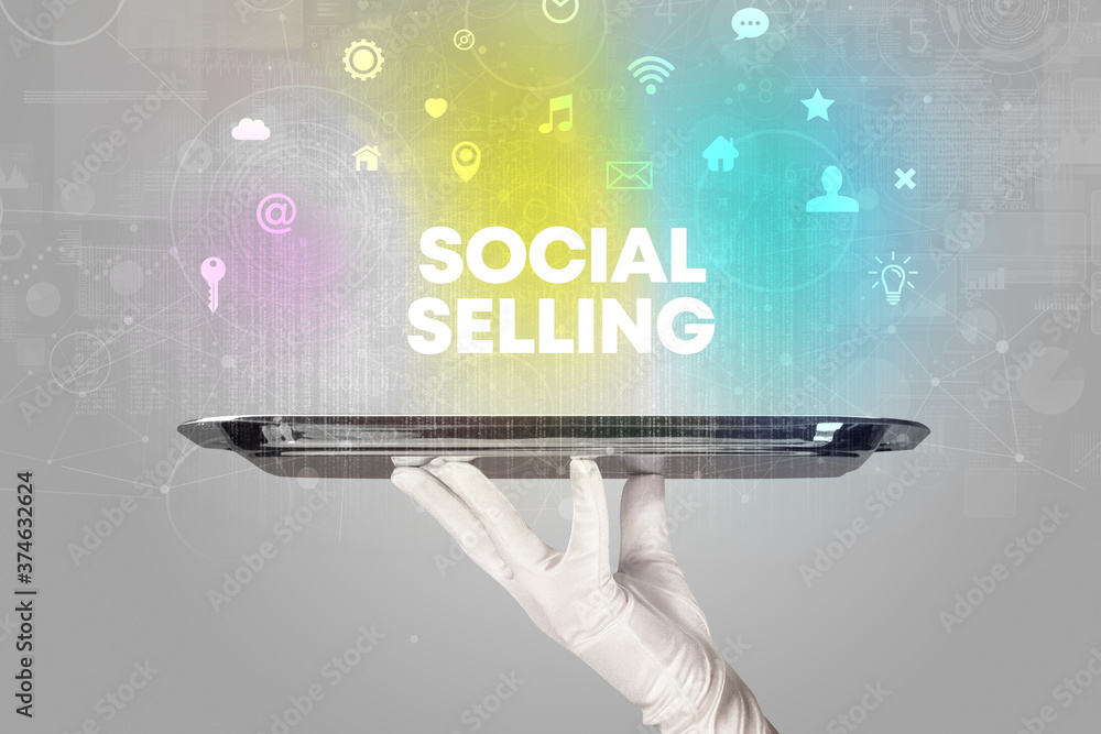 Waiter serving social networking with SOCIAL SELLING inscription, new media concept Waiter serving social networking with SOCIAL SELLING inscription, new media concept