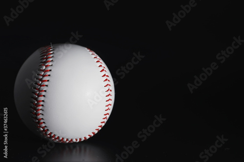 American traditional sports game. Baseball. Concept. Baseball ball and bats on a black table.