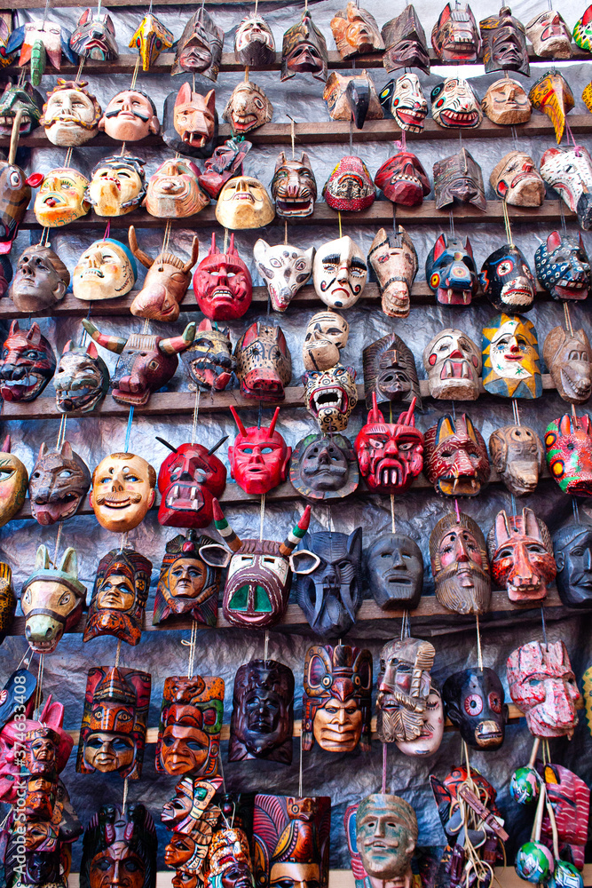 Different ethnic masks for sale on a market, Antigua Guatemala