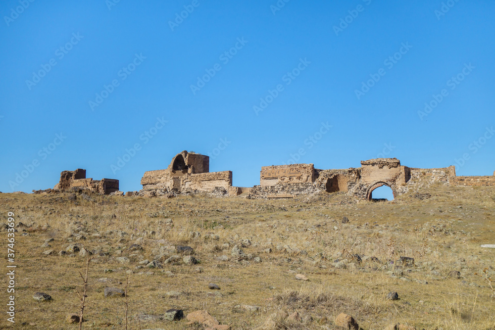 Panoramic view onto remains of medieval city Ani, near Kars, Turkey. It's included walls, towers, gates & abandoned field of stone ruins. City was founded in 5 century by Armenians. It's UNESCO object