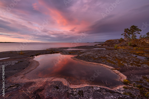 Rocky shore of the orthern lake at sunset, lake Ladoga