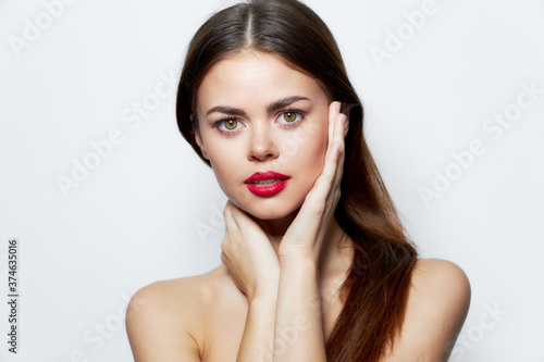 Lady bare shoulders Clean skin red lips hands near face attractive 
