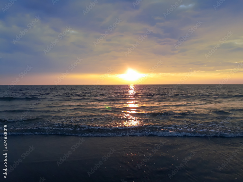 sunset on the beach, wave on the beach, beautiful sunset view in the Indian Ocean, sunset view in the goa,