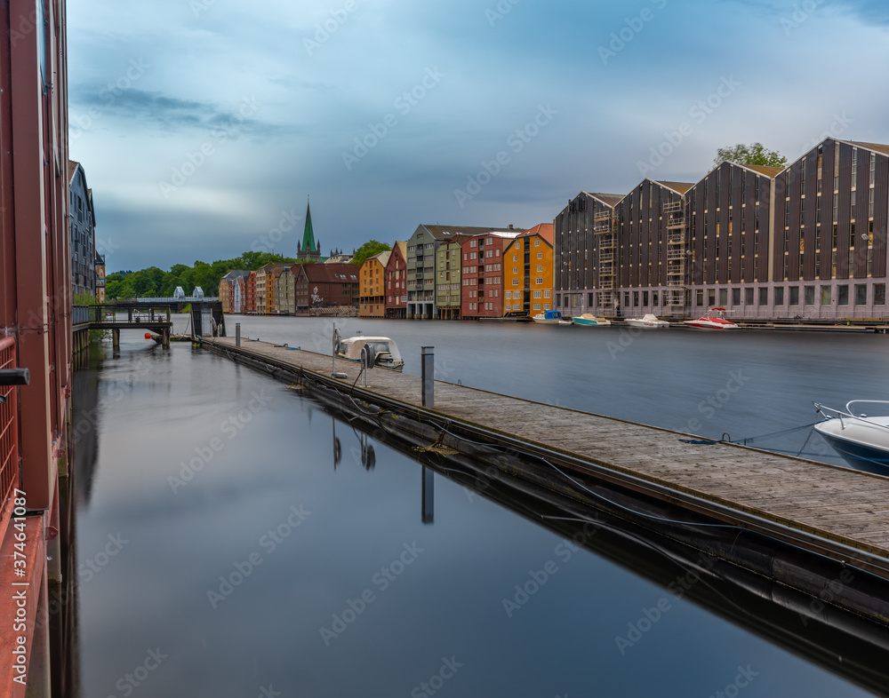 Naklejka premium The colorful and iconic old city wharves along the Nidelva river in Trondheim, Trondelag, Norway. Symbol of the historical role of Trondheim as a merchant city.