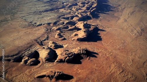 View from above of the red-colored, rugged rocky landscape in Monument Valley, the wild west of the USA. photo