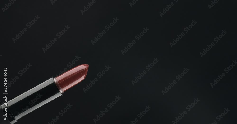 Rotation. Open lipstick on a black background. Isolated Rotation. Open lipstick on a black background. Isolated