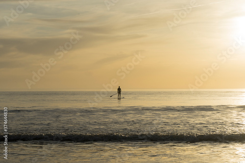 person doing paddle surfing in the sea during the sunset © carlosmoyo