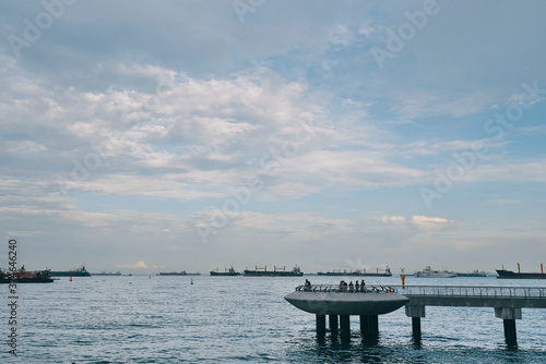 people watching ships at the singapore coastline