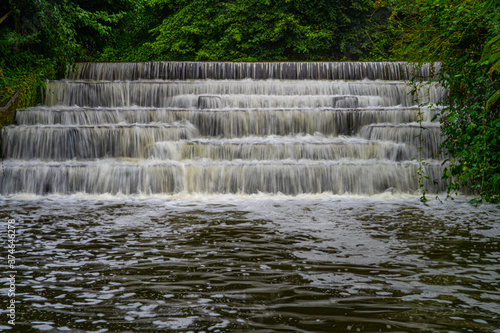 White Water flowing over weir low-level view at long exposure for blurred water effects and textures 