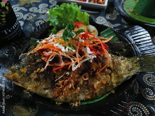 Local cuisine - fish with herbs in Indonesia