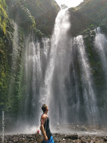Guy in front of a waterfall in Lombok - taking a break and refreshing