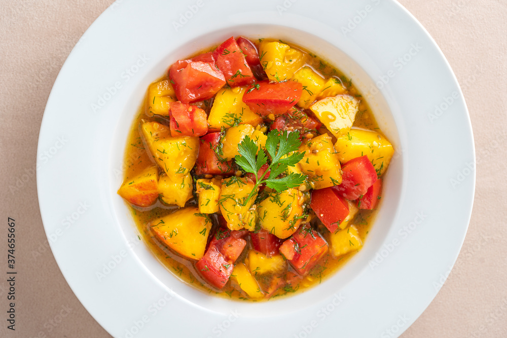 Colorful summer salad with tomato and peach, close up. Top view. Colorful summer salad with tomato and peach, close up. Top view.