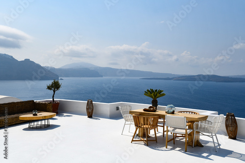 Wonerful view with chairs and table on a terrse in immerovigli greece