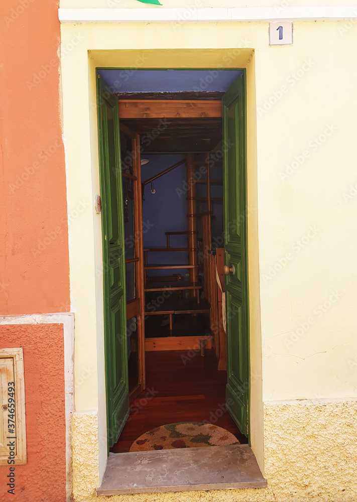 Fototapeta premium Old vintage wooden front door in an italian city. 30 August 2020, Rome, Italy 