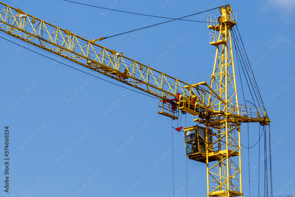 Construction site background. Hoisting cranes and new multi-storey buildings. I.ndustrial background.Building construction site work against blue sky Construction site background. Hoisting cranes and new multi-storey buildings. I.ndustrial background.Building construction site work against blue sky