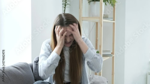 stressed upset young woman at home. shocked female feels stress, hopelessness, desperation, tearing hair on head, screaming. angry pretty girl shouts, goes insane. Negative emotions, stress, hysterics