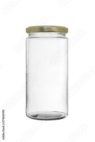 Empty glass jar of elongated shape, closed with a metal lid on a white background