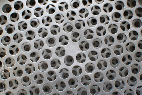 Old metal grating with round holes