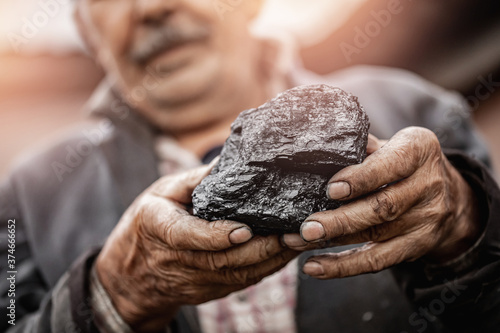 Miner holds coal palm. Concept mining, Top view
