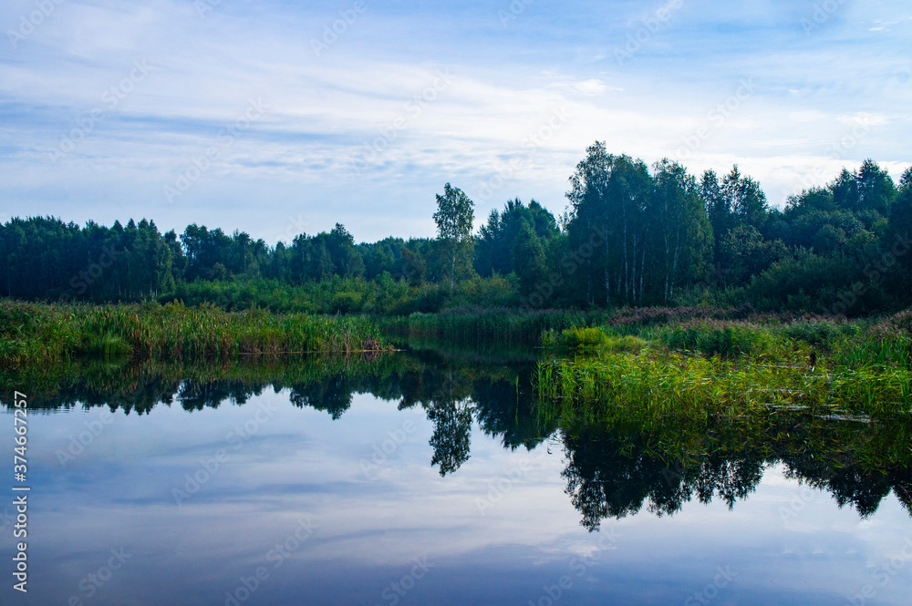 Morning sunrise with blue sky on a forest lake Morning sunrise with blue sky on a forest lake