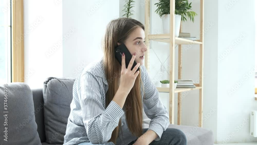 young pretty woman makes smartphone call, gets shocking unexpected news, feels stress, hopelessness. shock, frustration, anxiety. worried girl does not know what to do after phone conversation at home young pretty woman makes smartphone call, gets shocking unexpected news, feels stress, hopelessness. shock, frustration, anxiety. worried girl does not know what to do after phone conversation at home