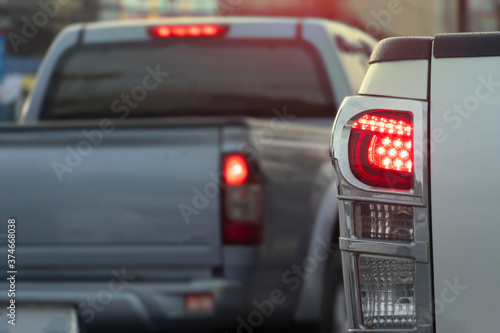 Close up rear light of pick up car. Turn on the brake lights and have another car.