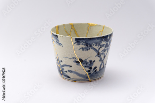 Wallpaper Mural Kintsugi blue and white decorated soba cups. Gold cracks restoration on old Japanese pottery restored with the antique Kintsugi restoration technique. The beauty of imperfections.  Torontodigital.ca