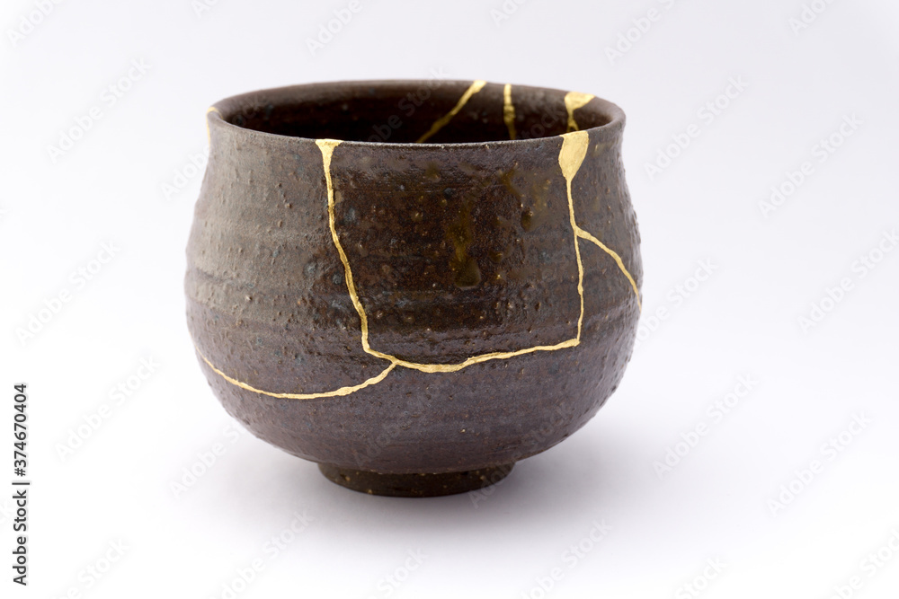 Kintsugi brown tea ceremony chawan bowl. Gold cracks restoration on old ...