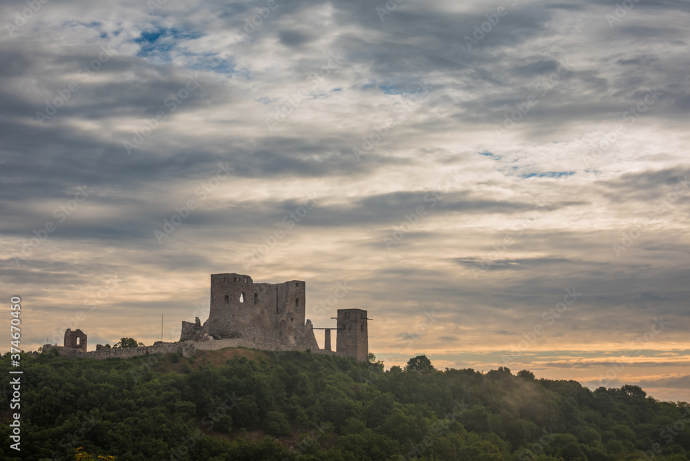 The ruins of the medieval castle of Csesznek sitting on a rock, Hungary