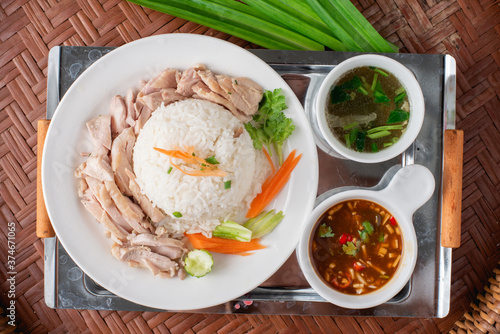 Rice steamed with chicken soup on wooden background.
