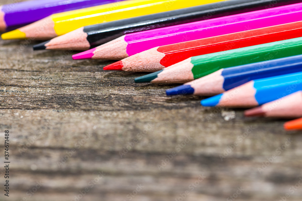 Color pencils on weathered aged pine wood boards close up macro shot, space for text. Color pencils on weathered aged pine wood boards close up macro shot, space for text.