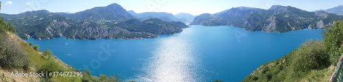 Panoramique : magnifique lac de Serre Ponçon devant la montagne alpine