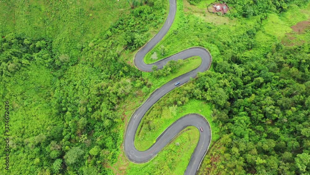Aerial view of Beautiful sky road over top of mountains with green jungle in Nan province, Thailand. Aerial view of Beautiful sky road over top of mountains with green jungle in Nan province, Thailand.