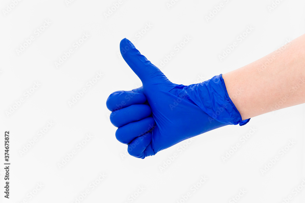 Hand in a blue diagnostic glove Hand in a blue diagnostic glove