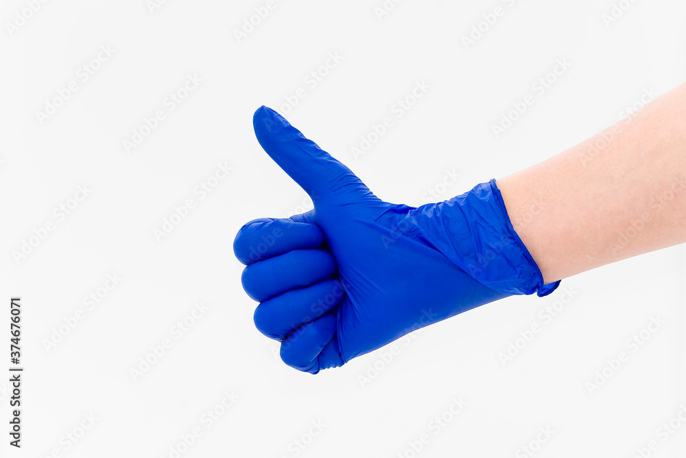 Hand in a blue diagnostic glove Hand in a blue diagnostic glove