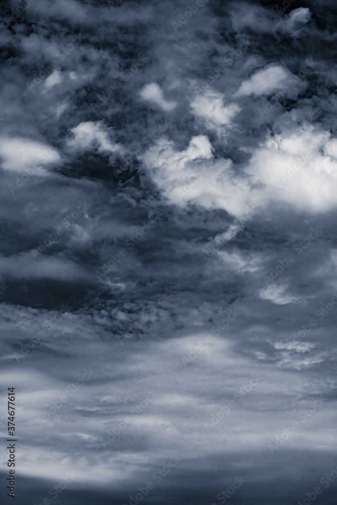 Dramatic dark gray sky after storm. Vertical photo.