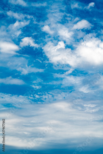 White color clouds found in the blue sky. Vertical photo