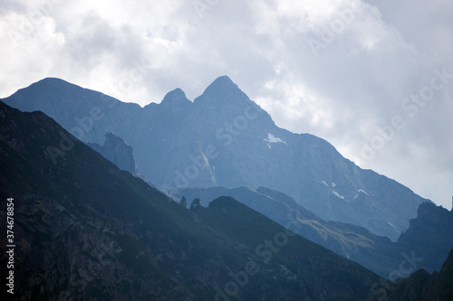 Fototapeta Naklejka Na Ścianę i Meble -  The meadows, the views and the peaks of the orobie alps during a summer afternoon, near the San Marco pass, Lombardy, Italy - June 2020