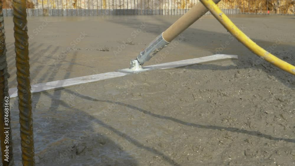 CLOSE UP, DOF Unrecognizable worker uses a levelling tool to spread the fresh mortar covering