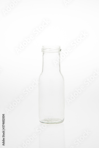 Isolated glass bottle on white background without cap.