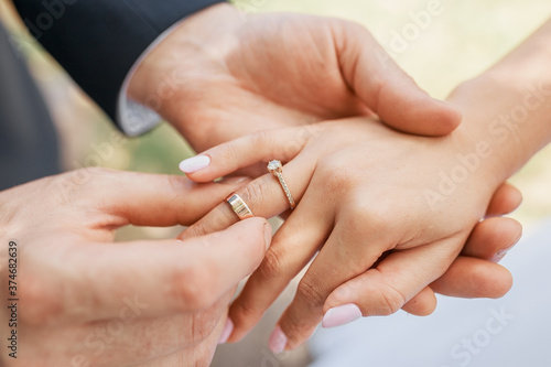 Wedding couple exchanging wedding rings. Wedding rings.