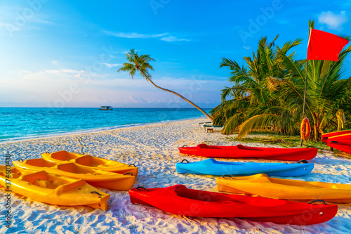 Fototapeta Naklejka Na Ścianę i Meble -  Boats for water activities in the Maldives lie on the shore in the sand. The concept of water sports, tourism.