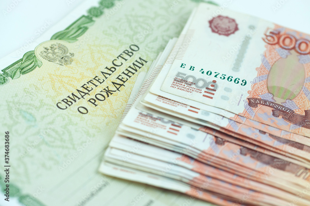 Russian money and birth certificate, concept of increasing birth rate Russian money and birth certificate, concept of increasing birth rate